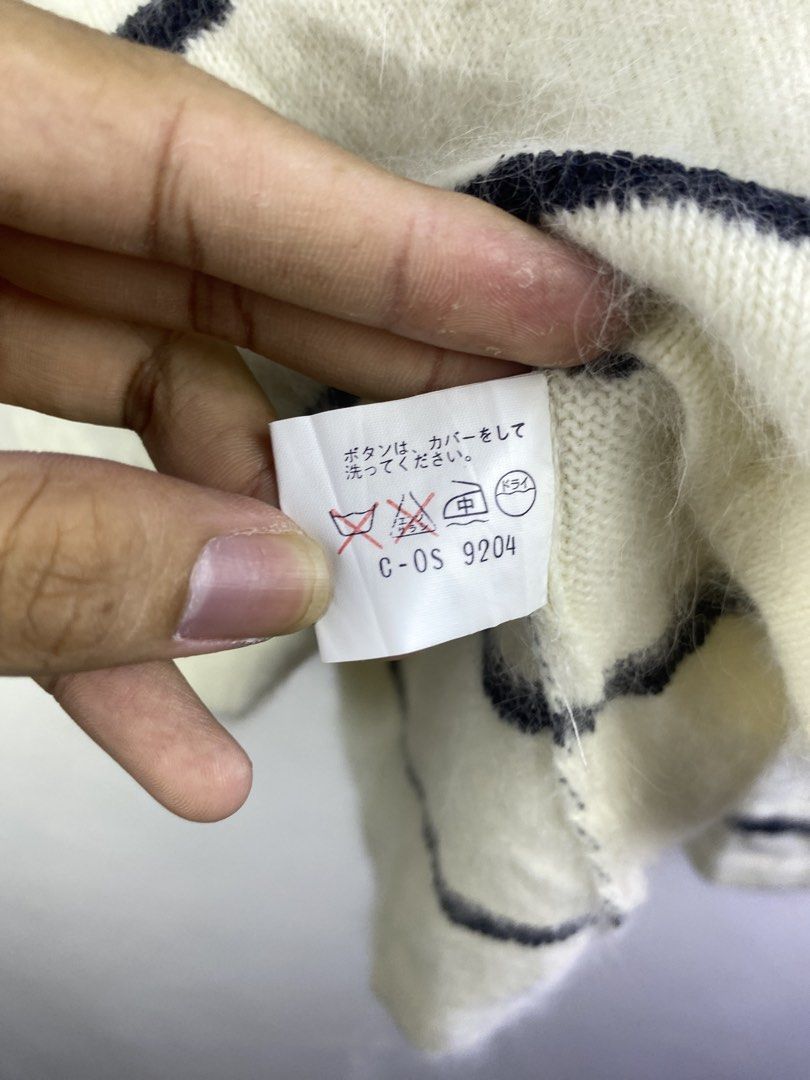 Givenchy Striped Knit Sweater with Logo Buttons (Category: Longsleeves) located in Manila. Submitted by declutterpromax (Listing ID 1469201973, Image 3). Description: - Brand: Givenchy - Color: White with black stripes - Details: Glossy black buttons with gold geometric logo accents - Material: Soft knit fabric - Design: Long sleeve, clean minimalist styling - Condition: Excellent pre-loved condition - Location: Metro Manila, Philippines - Shippi