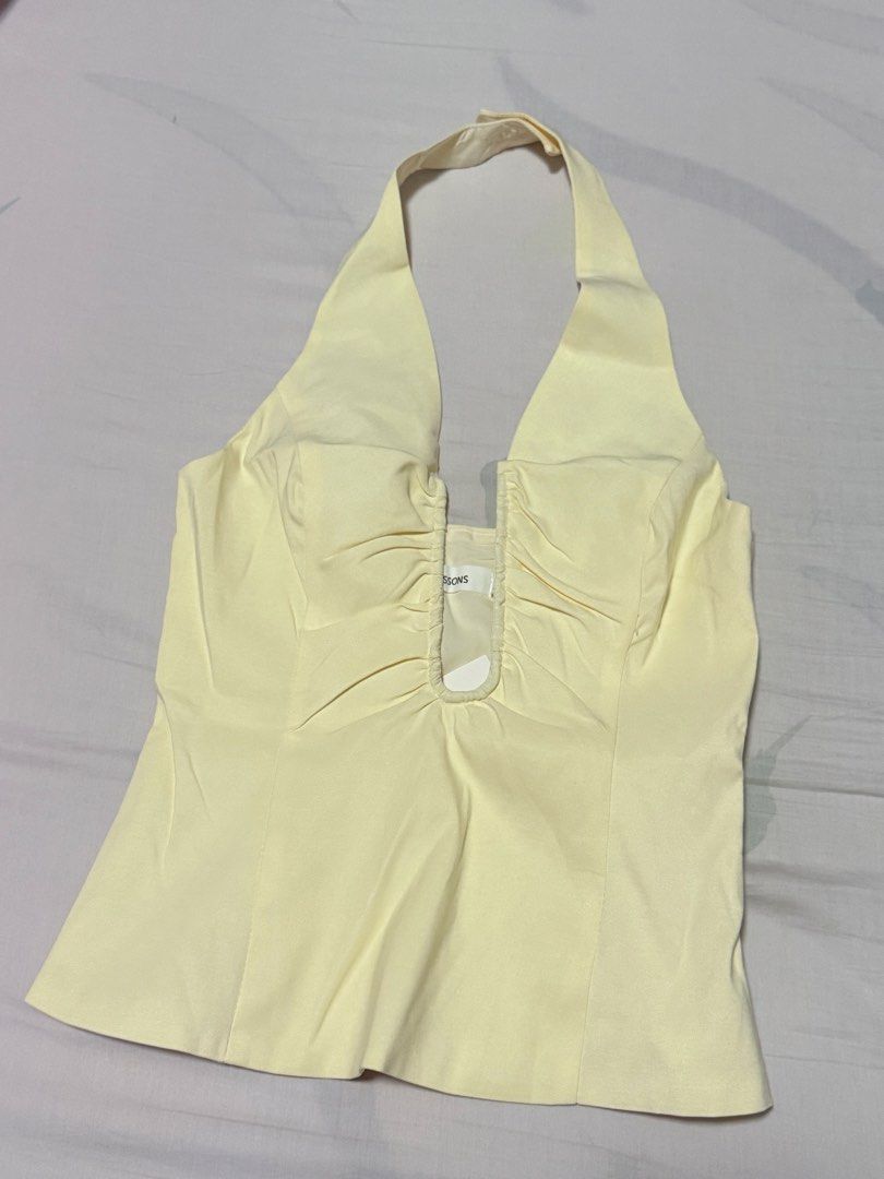Glassons ruched halter top (Category: Blouses) located in Manila. Submitted by livvy.edit (Listing ID 1469309524, Image 3). Description: - Condition: Brand new with tags (BNWT) RFS: Bought the wrong size 📦 Can do shipping (buyer shoulders fee) - Style: Halter neck, sleeveless, fitted silhouette - Details: Chic ruched detailing along the deep V-neckline - Perfect for casual outings, dates, or summer parties!.