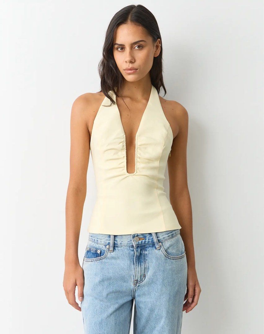 Glassons ruched halter top (Category: Blouses) located in Manila. Submitted by livvy.edit (Listing ID 1469309524, Image 1). Description: - Condition: Brand new with tags (BNWT) RFS: Bought the wrong size 📦 Can do shipping (buyer shoulders fee) - Style: Halter neck, sleeveless, fitted silhouette - Details: Chic ruched detailing along the deep V-neckline - Perfect for casual outings, dates, or summer parties!.