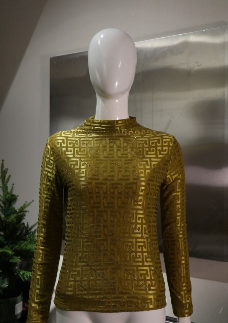 Gold patterned long sleeve mock neck top (Category: Longsleeves) located in Paranaque City. Submitted by skulkch (Listing ID 1469361012, Image 2). Description: - Color/Pattern: Gold with all-over geometric maze pattern - Design: Mock neck collar with diagonal sparkly rhinestone rows on the front - Fit: Fitted silhouette - Material: Smooth and stretchy fabric - Occasion: Ideal as an evening wear or party statement piece.