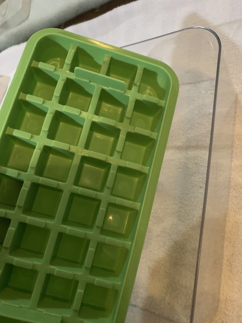 Green and Clear Ice Cube Tray with Storage Box (Category: Food Organization & Storage) located in Baguio. Submitted by grazia.ivy (Listing ID 1469302149, Image 2). Description: - Color: Green grid tray with clear storage container - Includes: Ice tray, container, lid, and green top handle - Function: Convenient setup for making and storing ice cubes - Condition: Clean and simple kitchen accessory ready for your freezer.