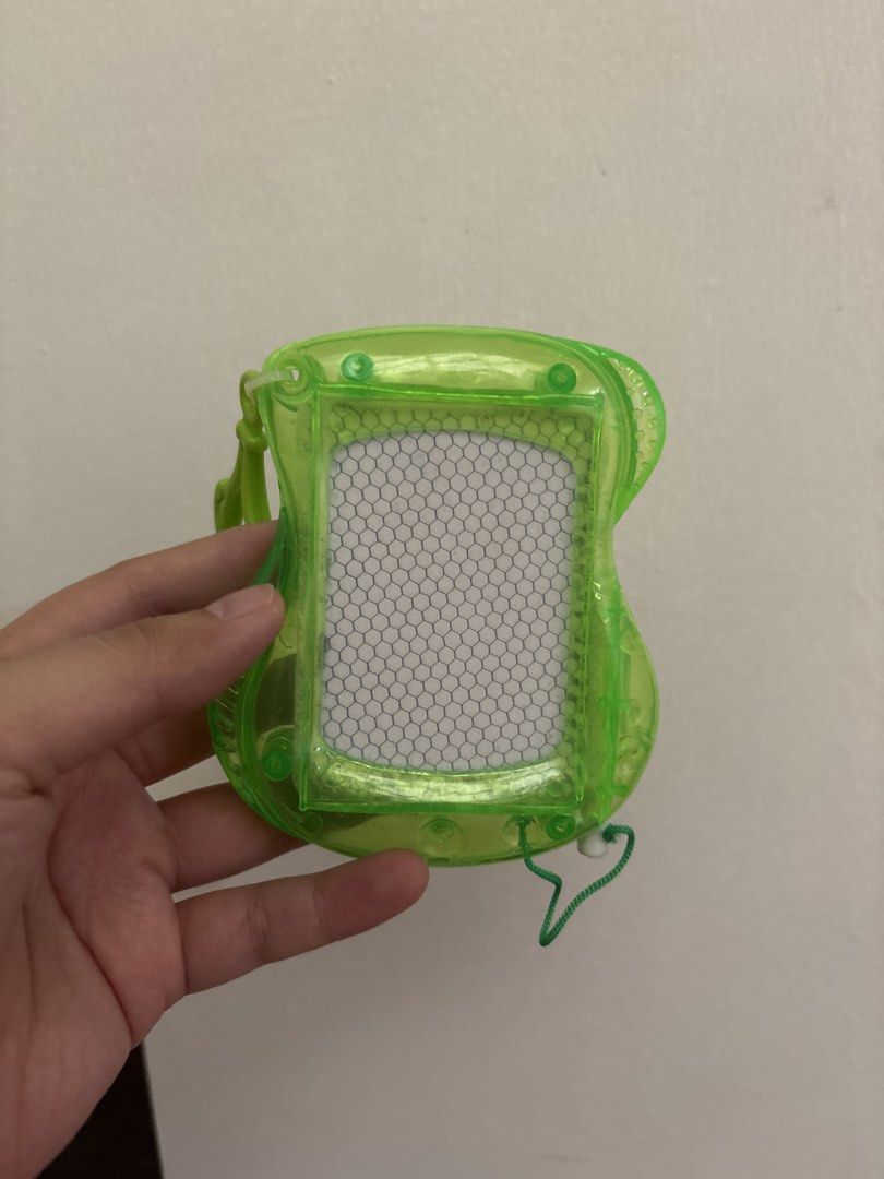 Green Translucent Mini Magnetic Drawing Board Toy (Category: Educational & Learning Toys) located in Quezon City. Submitted by msuyo (Listing ID 1469391311, Image 1). Description: - Color/Design: Bright green translucent frame with a cool honeycomb pattern - Size: Compact and handheld, perfect for travel - Features: Attached string loop for easy carrying - Condition: Clean and ready to play with - Use: Fun little gadget for doodling anywhere you 