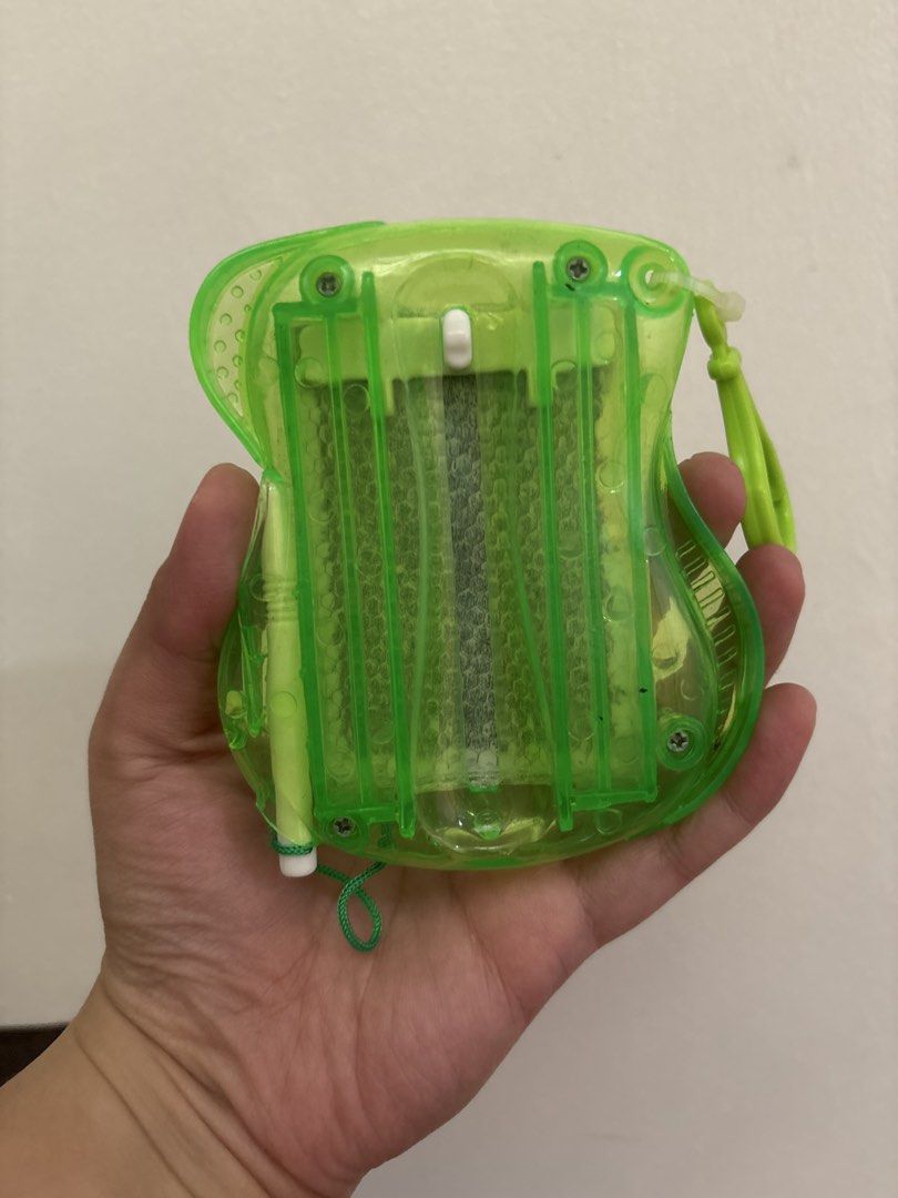 Green Translucent Mini Magnetic Drawing Board Toy (Category: Educational & Learning Toys) located in Quezon City. Submitted by msuyo (Listing ID 1469391311, Image 2). Description: - Color/Design: Bright green translucent frame with a cool honeycomb pattern - Size: Compact and handheld, perfect for travel - Features: Attached string loop for easy carrying - Condition: Clean and ready to play with - Use: Fun little gadget for doodling anywhere you 