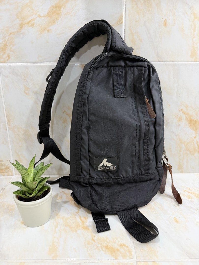 Gregory Black Crossbody Bag (Category: Sling Bags) located in Manila. Submitted by haveago0dthrift (Listing ID 1469281501, Image 1). Description: - Brand: Gregory - Color: Classic Black - Material: Durable heavy-duty nylon with sturdy leather zipper pulls - Comfort: Padded back panel and single adjustable strap with D-ring - Storage: Main compartment with internal pocket - Condition: Clean interior, minor paint wear on metal snap buttons - Best f