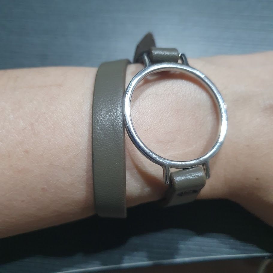 Grey wrap-around leather bracelet with ring (Category: Bracelets) located in Caloocan City. Submitted by mma_222 (Listing ID 1469195251, Image 3). Description: - Color: Grey - Material: Leather with silver-toned metal hardware - Design: Wrap-around style (goes twice around the wrist) with circular watch case ring - Length: Approx. 42 cm with adjustable sizing holes - Condition: Clean surface, minimal wear.