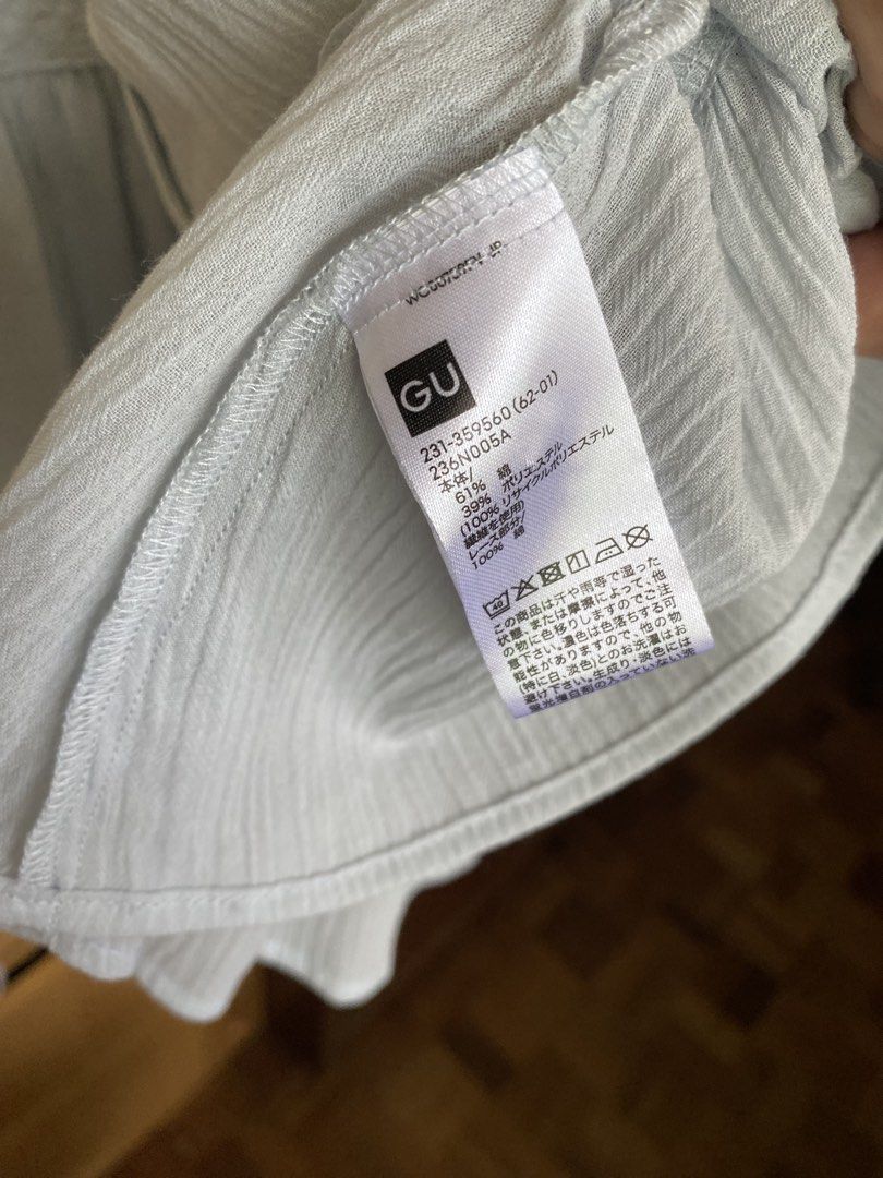 GU Light Blue Button-Up Blouse Size S (Category: Blouses) located in Manila. Submitted by freestone_f18729 (Listing ID 1469183861, Image 3). Description: - Brand: GU - Size: S - Color: Light Blue - Material: 61% Cotton, 39% Polyester (Cotton lace trim) - Design: Button-up front, pleated panels with delicate lace inserts, layered ruffle sleeves, and a flared peplum hem - Origin: Made in Cambodia - Condition: Excellent / Ready to wear.