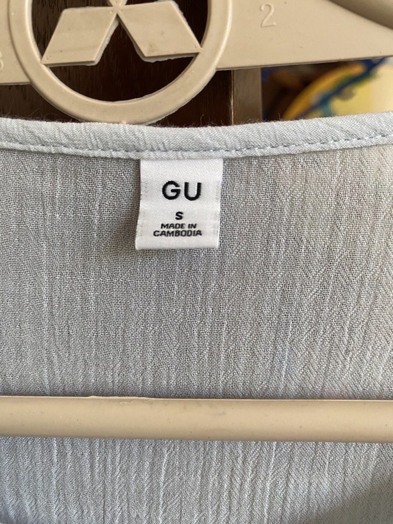 GU Light Blue Button-Up Blouse Size S (Category: Blouses) located in Manila. Submitted by freestone_f18729 (Listing ID 1469183861, Image 2). Description: - Brand: GU - Size: S - Color: Light Blue - Material: 61% Cotton, 39% Polyester (Cotton lace trim) - Design: Button-up front, pleated panels with delicate lace inserts, layered ruffle sleeves, and a flared peplum hem - Origin: Made in Cambodia - Condition: Excellent / Ready to wear.