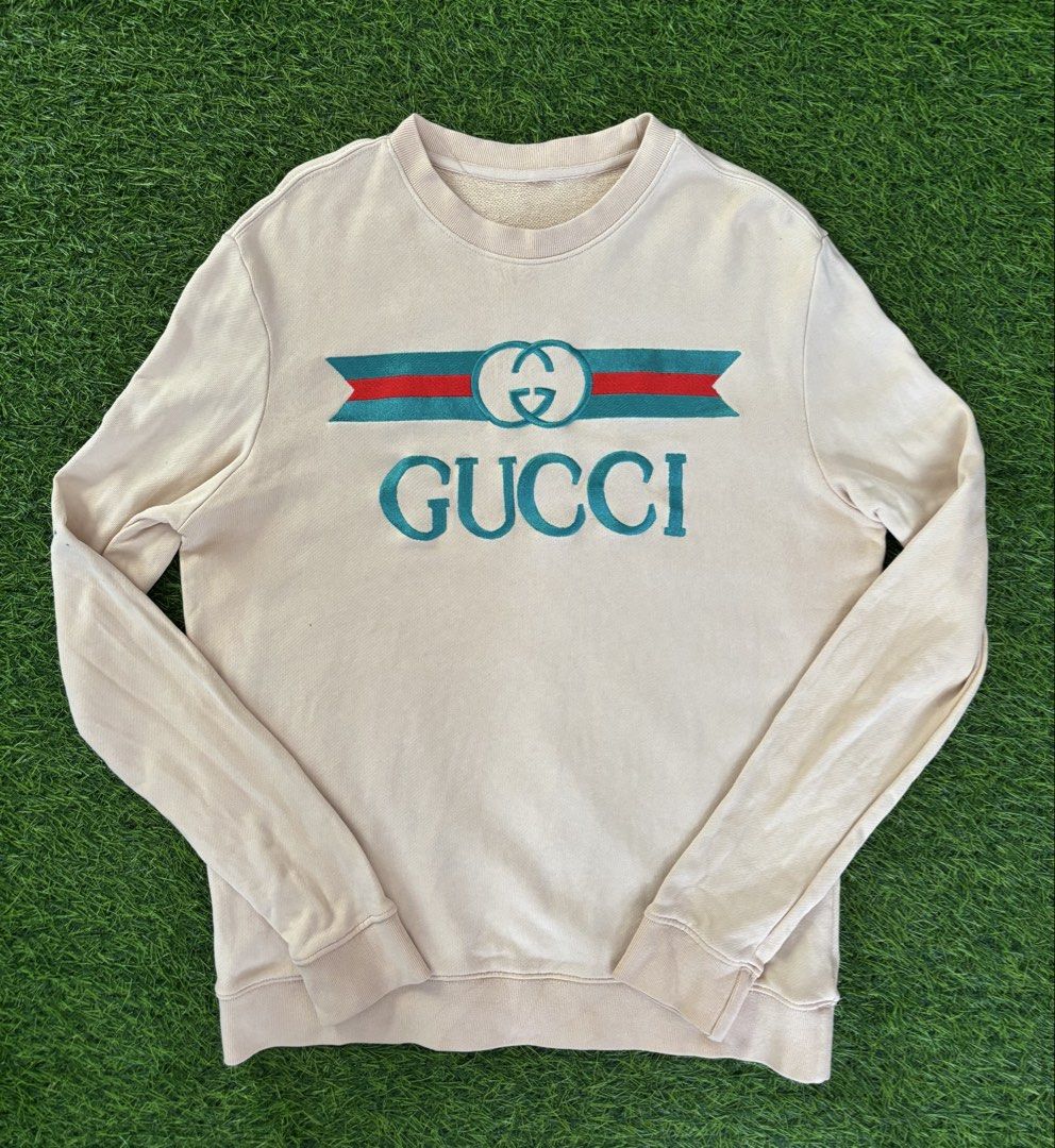 Gucci Beige Logo Sweatshirt (Category: Coats, Jackets and Outerwear) located in Makati City. Submitted by rare_thrift_stuff (Listing ID 1469164737, Image 1). Description: - Authentic Gucci Sweatshirt - Color: Beige - Material: 100% Cotton - Made in Italy - Features iconic green and red striped ribbon with interlocking G embroidery - Ribbed collar, cuffs, and hem for a snug fit - Style code: 409708-XJ064 - Clean interior with original standard car