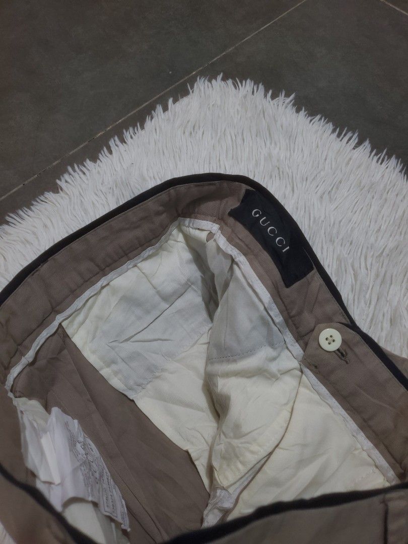 Gucci Beige Trousers Pants (Category: Trousers) located in Manila. Submitted by royalrabbit.7b2a11 (Listing ID 1469196936, Image 2). Description: - Brand: Gucci - Color: Beige with contrast side piping - Size: 29 - Material: 98% cotton, 2% elastane (Lining: 100% viscose) - Origin: Made in Italy - Features: Classic tailored fit, clean lines, secure button closure, and original interior Gucci branding tags.