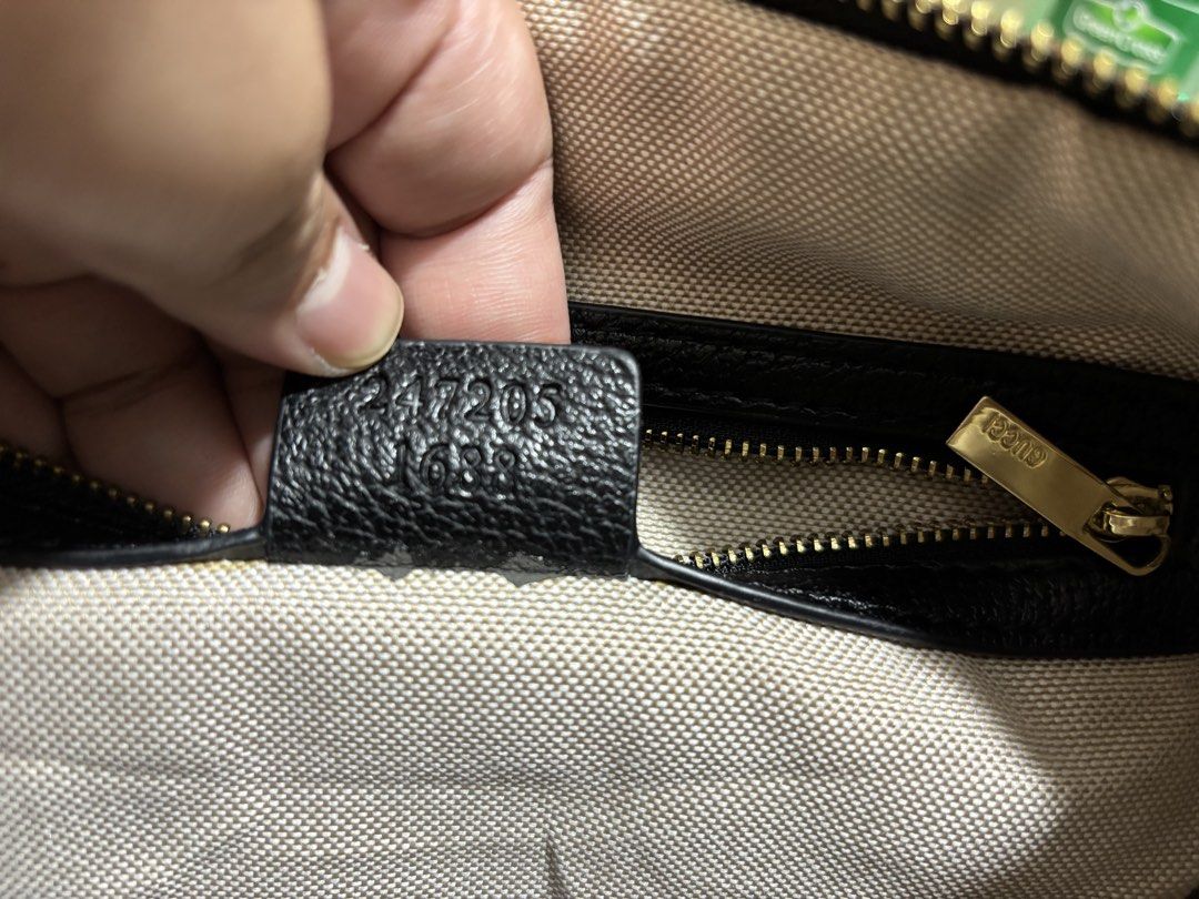 Gucci Black Nylon Webbing Shoulder Bag (Category: Luxury Bags & Wallets) located in Makati City. Submitted by jhonnared (Listing ID 1469173867, Image 1). Description: Gucci duffel bag in black nylon with signature green and red web stripe down the center. Black leather trim and top handles. Includes detachable and adjustable leather shoulder strap. Gold-tone hardware with engraved Gucci zipper pull. Light-colored fabric interior lining with inter