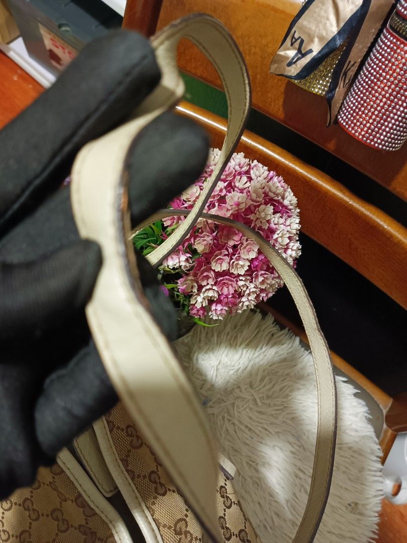 Gucci GG Canvas Tote Bag with Bow (Category: Tote Bags) located in Digos. Submitted by chihanu (Listing ID 1469201404, Image 3). Description: - Gucci tote bag - Beige GG canvas fabric with light-colored leather straps and trim - Charming small decorative leather bow on the front center - Secure magnetic snap closure at the top - Spacious interior to fit all your daily essentials - Condition note: Dual shoulder handles show some visible edge wear 