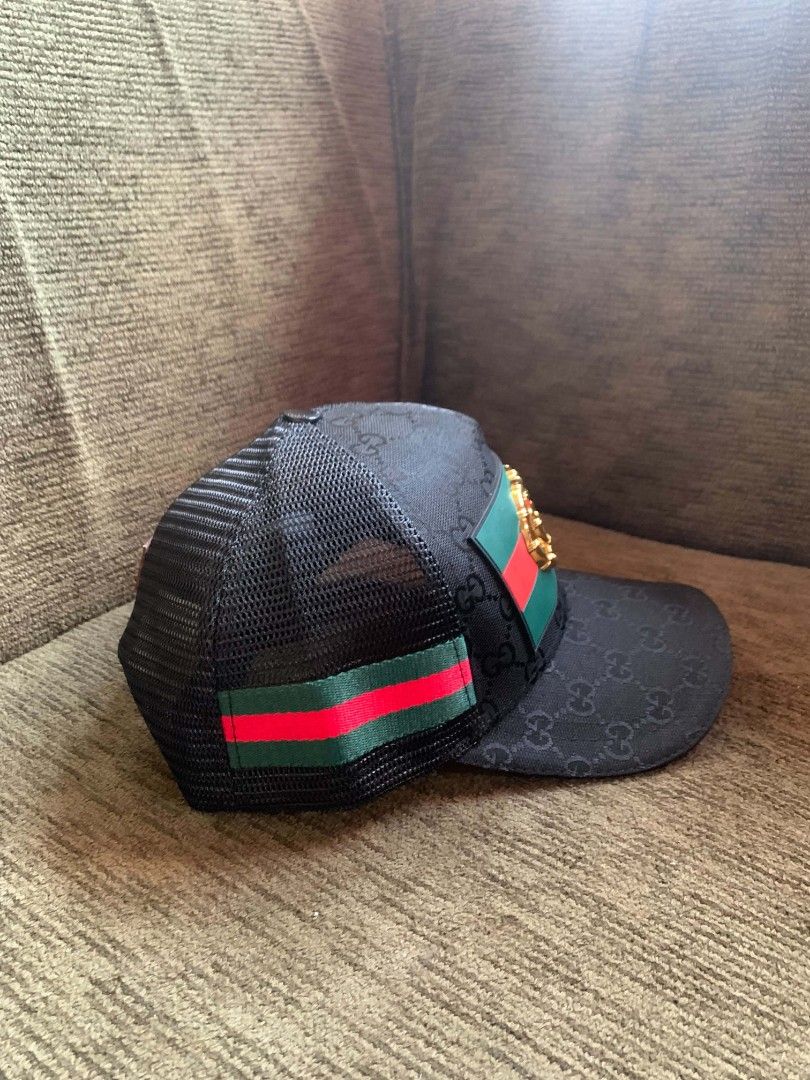 Gucci GG Monogram Mesh Trucker Hat (Category: Caps & Hats) located in San Juan City. Submitted by findmorelux (Listing ID 1469226271, Image 1). Description: - designer trucker hat - Classic black mesh design with GG monogram pattern - Front patch featuring the signature red and green Web stripe and gold bamboo double G logo - Breathable mesh back panels for everyday comfort - Adjustable snapback closure for a custom fit - Brown leather Gucci logo