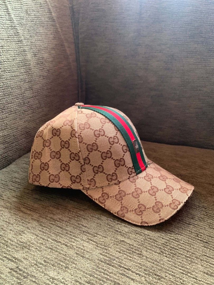 Gucci GG Supreme Baseball Cap with Web Stripe (Category: Caps & Hats) located in San Juan City. Submitted by findmorelux (Listing ID 1469226473, Image 1). Description: - Brand: Gucci - Design: Iconic GG supreme canvas with signature green-red-green web stripe - Fit: Adjustable leather strap at the back with embossed Gucci logo and gold-tone hardware - Interior: Authentic Gucci branded taping and tags - Style: Classic designer streetwear, perfect 