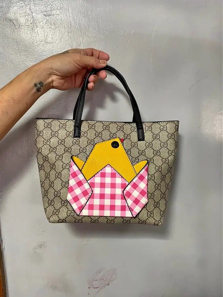 Gucci GG Supreme Tote Bag with Bird Patch (Category: Tote Bags) located in Gingoog City. Submitted by talianjeri27046 (Listing ID 1469226595, Image 1). Description: - Authentic Gucci tote in classic GG Supreme canvas - Eye-catching yellow and pink gingham bird patch on the front - Premium black leather top handles and trim - Vibrant yellow interior lining equipped with a convenient slip pocket and branded patch - Compact and lightweight design, i