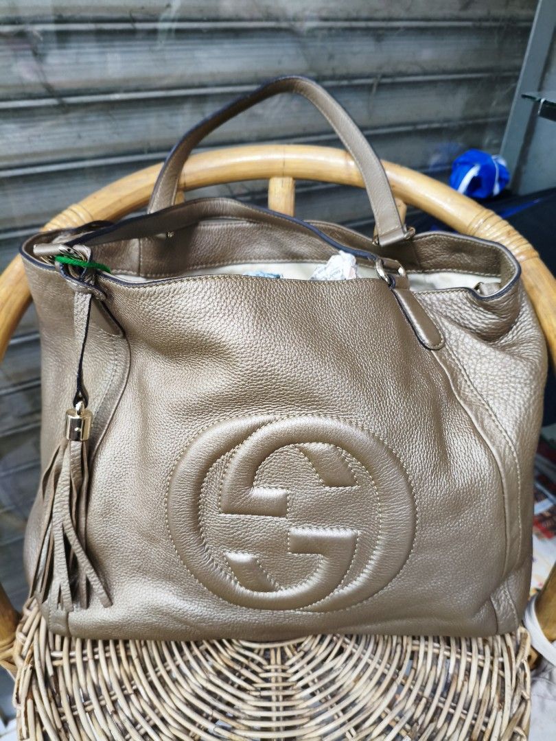 Gucci gold pebbled leather medium Soho shoulder bag (Category: Luxury Bags & Wallets) located in Puerto Princesa. Submitted by lotsstuff (Listing ID 1469266879, Image 3). Description: Well-maintained with minor scuffs/darkening/creases in some areas, slight cracks on exterior, snagging on handle(s) & wear on metal. Hardware Gold Tone Exterior Material Leather Interior Material Canvas Origin Italy Color Gold Style Gucci Soho Length 35 cm Width 18 
