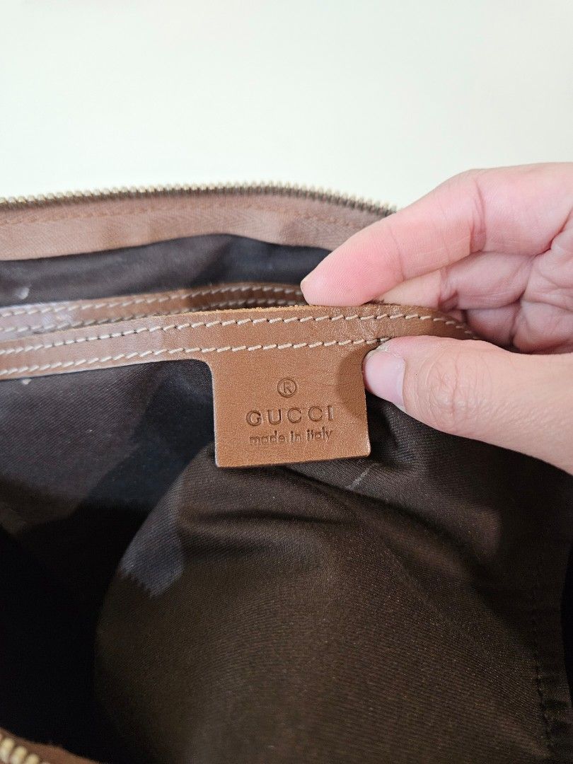 Gucci Monogram Canvas Tote Handbag Brown (Category: Luxury Bags & Wallets) located in Quezon City. Submitted by andyrms (Listing ID 1469208798, Image 3). Description: - Authentic Gucci tote bag with classic monogram canvas pattern - Premium brown leather handles and trim - Secure top zip closure - Spacious interior with fabric lining and 'Gucci Made in Italy' leather tag - Verified serial number: 189899 493025 on reverse of leather tag - Ideal ev