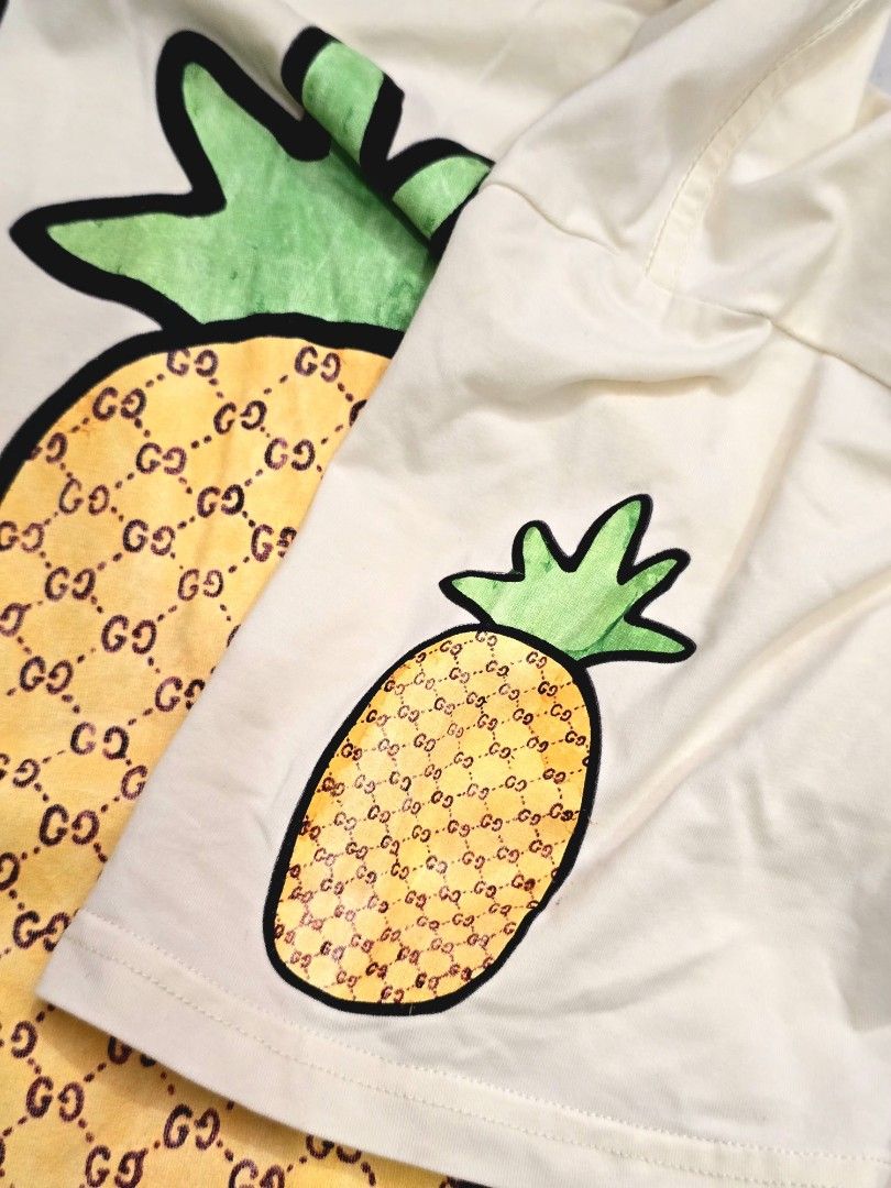 GUCCI "Pineapple & Pair 'N' Dice" Doodle Graphic Tee (Category: Luxury Apparel) located in Pasay City. Submitted by seventhrift.26 (Listing ID 1469280086, Image 3). Description: ​Size: Medium (M) ​Color: Off-White / Light Cream ​Condition: Pre-loved / Good Condition (Please refer to detailed photos for exact condition) ​✨ Features the iconic pineapple GG monogram print with doodle graphics on front and sleeve. Original tags attached. Clean and we