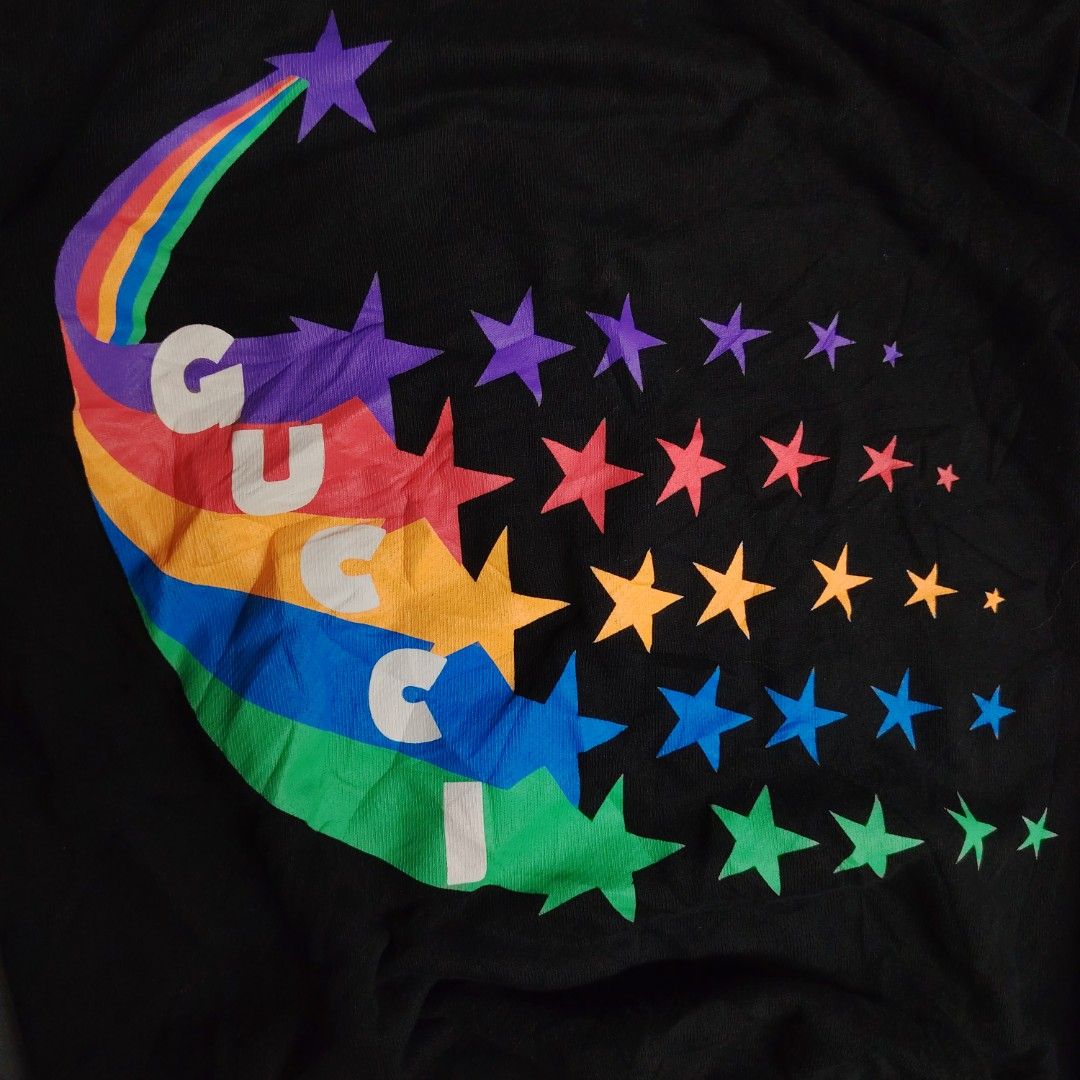 Gucci Rainbow Star Black Sweatshirt (Category: Coats, Jackets and Outerwear) located in Manila. Submitted by maetots (Listing ID 1469173994, Image 2). Description: - Brand: Gucci - Color: Black with multicolored rainbow star and logo graphic - Size: Medium - Material: 100% cotton, Made in Italy - Style: Crewneck pullover with ribbed cuffs and hem - Condition: Label tags attached inside collar.