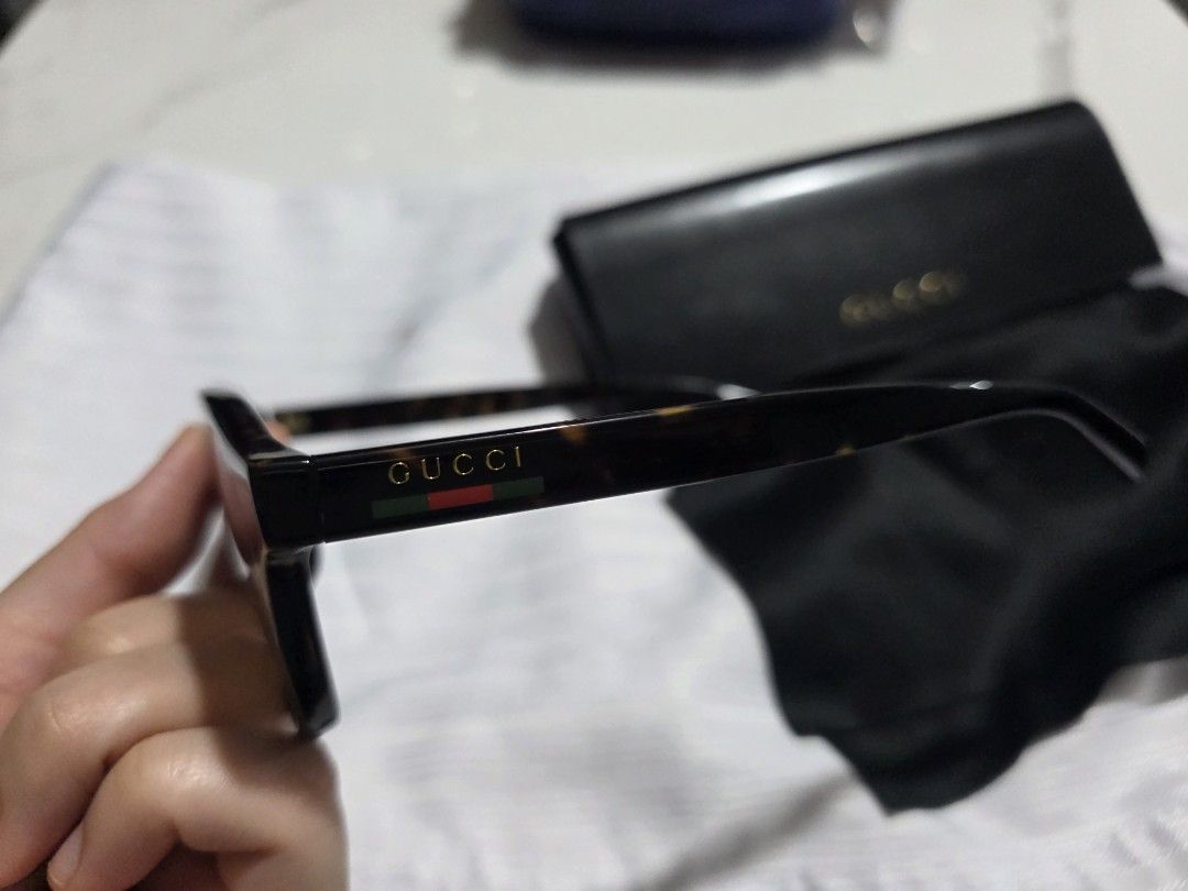 Gucci Tortoise shell Sunglasses with Case (Category: Sunglasses & Eyewear) located in Davao. Submitted by abp0627 (Listing ID 1469244733, Image 2). Description: - Brand: Gucci - Style: Classic thick frames in tortoiseshell acetate - Lenses: Brown tinted - Detail: Signature green and red stripe on temples - Inclusions: Original hard leather case and black satin pouch with embossed branding - Condition: Great accessory, perfect for sunny days.