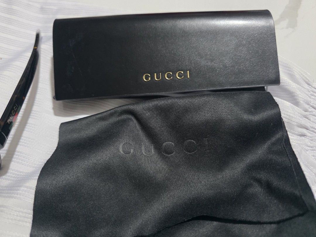 Gucci Tortoise shell Sunglasses with Case (Category: Sunglasses & Eyewear) located in Davao. Submitted by abp0627 (Listing ID 1469244733, Image 3). Description: - Brand: Gucci - Style: Classic thick frames in tortoiseshell acetate - Lenses: Brown tinted - Detail: Signature green and red stripe on temples - Inclusions: Original hard leather case and black satin pouch with embossed branding - Condition: Great accessory, perfect for sunny days.
