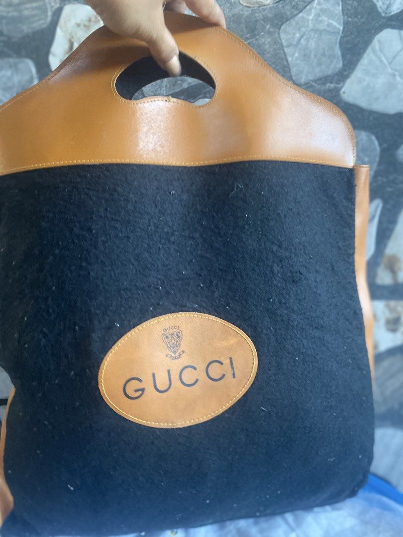 Gucci Wool and Leather Tote Bag (Category: Tote Bags) located in Bacolod City. Submitted by chuchaystuffs (Listing ID 1469165196, Image 1). Description: - Authentic Gucci tote bag - Material: Black wool blend (70% rayon, 30% wool) - Contrast brown leather top handles and side panels - Signature oval leather Gucci logo patch on the front - Stylish cutout handles at the top - Made in Italy tag stitched inside - Condition: Excellent/Pristine.