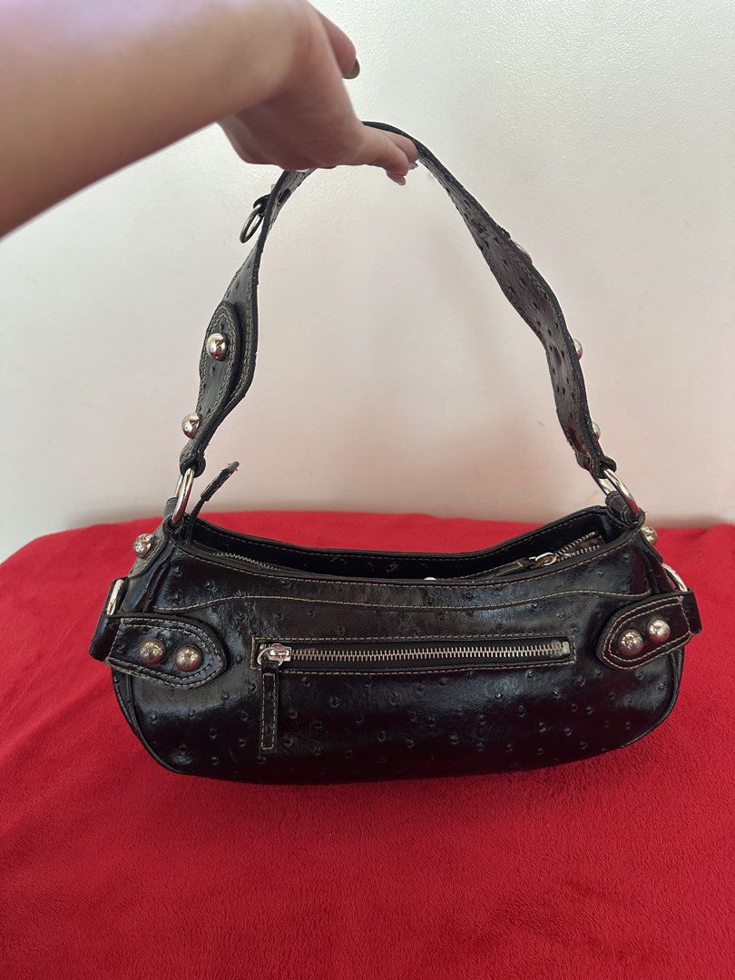 Guess Black Ostrich Texture Handbag Ilyse (Category: Shoulder Bags) located in Manila. Submitted by goldenhorse-dafc (Listing ID 1469211205, Image 3). Description: - Brand: Guess - Style: Black shoulder bag with chic ostrich texture pattern - Hardware: Silver-tone metal with cool stud accents on the strap ends and front logo plate - Pockets: Convenient exterior zippered back pocket and spacious main compartment - Interior: Stylish brown and beige
