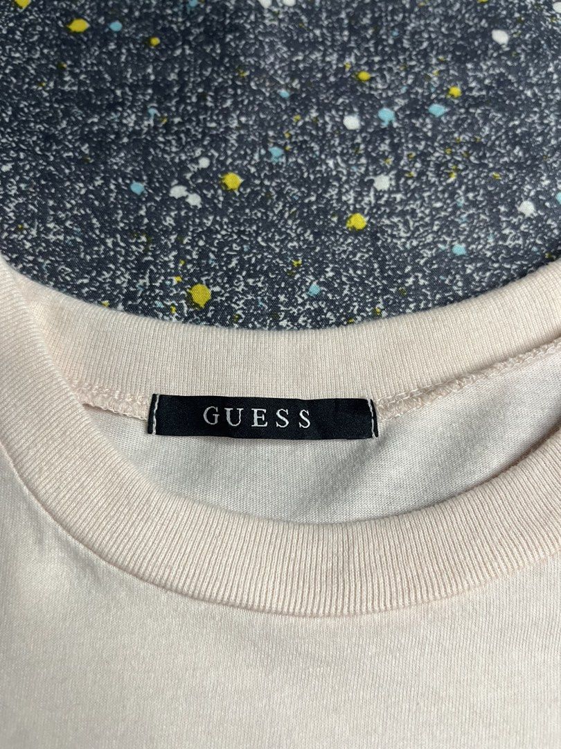 Guess Embossed Logo Crew Neck T-Shirt Pink Medium (Category: Shirts) located in Manila. Submitted by lj_thrifter (Listing ID 1469168739, Image 3). Description: - Brand: Guess - Color: Pale Pink - Size: M - Color rate 9.5/10 - No issue - Material: 100% Cotton (Made in Korea) - Fit: Standard fit - Design: Classic crew neck with tonal embossed triangular logo on chest - Style: Clean design, ideal for everyday casual wear.