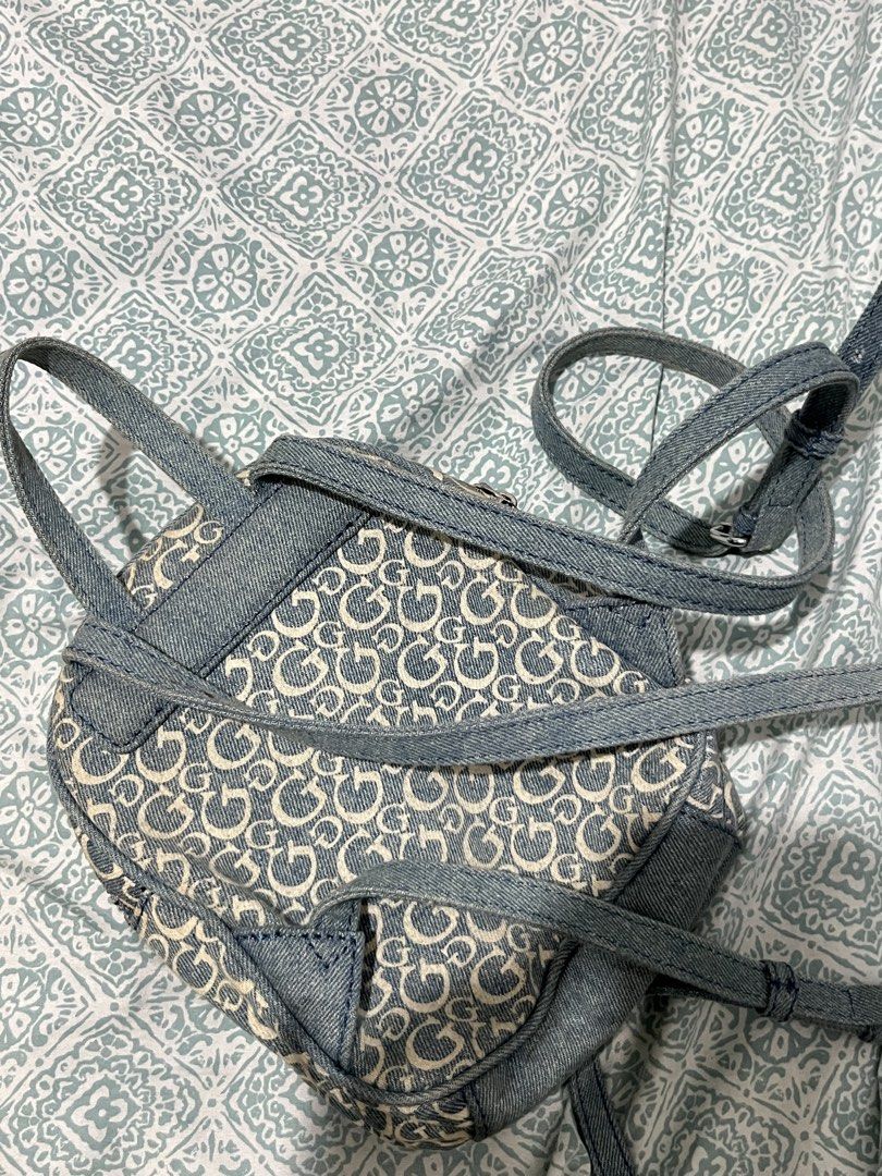 Guess Los Angeles Denim Monogram Mini Backpack (Category: Backpacks) located in Rizal. Submitted by cwassnut (Listing ID 1469217017, Image 2). Description: - Brand: Guess Los Angeles - Material: Blue denim with all-over monogram 'G' pattern - Hardware: Silver-tone with front metal logo plaque - Compartments: Main compartment with internal zip pocket plus front zipped pocket - Straps: Adjustable denim shoulder straps and top grab handle - lightly 