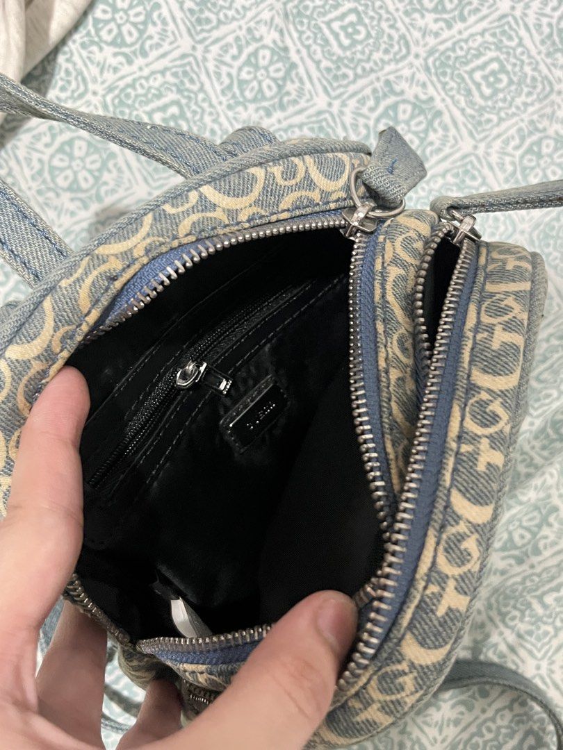 Guess Los Angeles Denim Monogram Mini Backpack (Category: Backpacks) located in Rizal. Submitted by cwassnut (Listing ID 1469217017, Image 3). Description: - Brand: Guess Los Angeles - Material: Blue denim with all-over monogram 'G' pattern - Hardware: Silver-tone with front metal logo plaque - Compartments: Main compartment with internal zip pocket plus front zipped pocket - Straps: Adjustable denim shoulder straps and top grab handle - lightly 