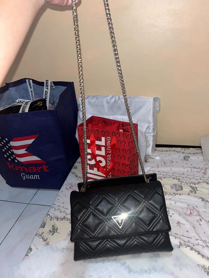 Guess Quilted Black Shoulder Bag with Chain Strap (Category: Shoulder Bags) located in Mandaluyong City. Submitted by judened (Listing ID 1469299225, Image 2). Description: - Brand: Guess - Material: Soft leather-like material in classic black - Design: Quilted texture with iconic triangle logo badge - Hardware: Elegant gold-tone chain strap and accents - Interior: Clean branded lining with multiple compartments and secure zip pockets - Versatili