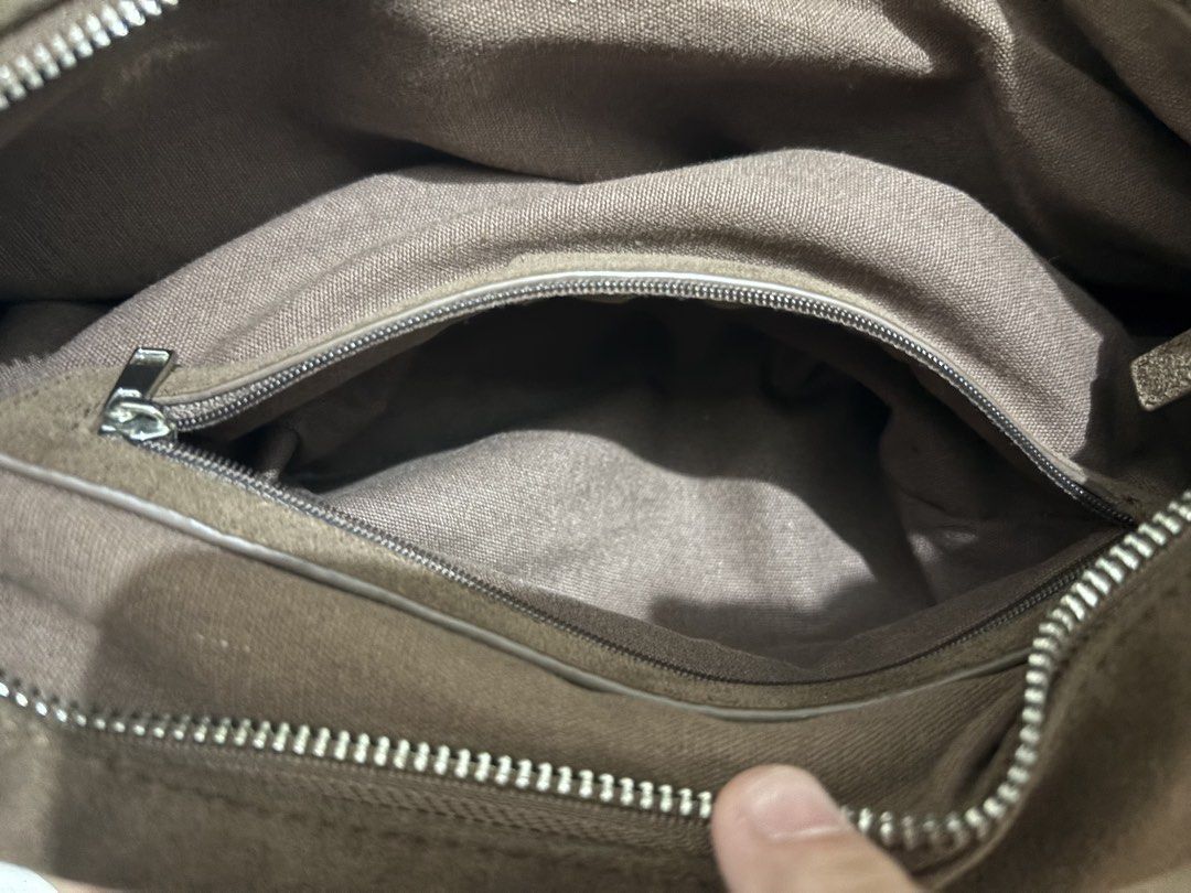 GVN Brown suede shoulder bag with silver hardware (Category: Shoulder Bags) located in Pasay City. Submitted by _mcrnj (Listing ID 1469336186, Image 3). Description: - Material: Premium brown suede - Closure: Secure zip top - Interior: Clean fabric lining with a zippered side pocket for extra organization - Strap: Thick shoulder strap for comfortable carrying - Details: Minimalist metal branding badge on the front.
