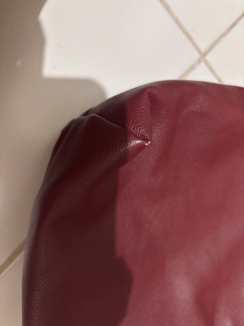 GVN Maroon Red Leather Shoulder Bag (Category: Shoulder Bags) located in Pasay City. Submitted by _mcrnj (Listing ID 1469336432, Image 3). Description: - Color & Material: Deep maroon red in textured faux leather - Design: Soft, slouchy shape with a wide strap and chic gold hardware ring detail - Interior: Clean white canvas lining - Closure: Secure top zip closure - Condition: Good pre-loved condition with a small scuff mark on one bottom corner