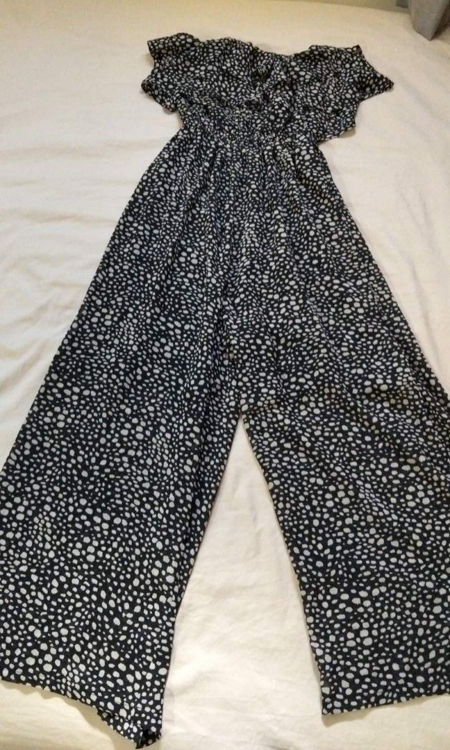 GYDA Black and White Dot Jumpsuit (Category: Jumpsuits) located in Tacloban City. Submitted by thead.declutters (Listing ID 1469216018, Image 1). Description: - Brand: GYDA - Design: Chic black & white dotted pattern with a ruffled neckline - Fit & Comfort: Lightweight material, fully lined, elastic waistband, and easy pull-on style - Features: Short flutter sleeves and trendy wide-legged pants - Perfect for: Casual outings, dates, or warm weathe