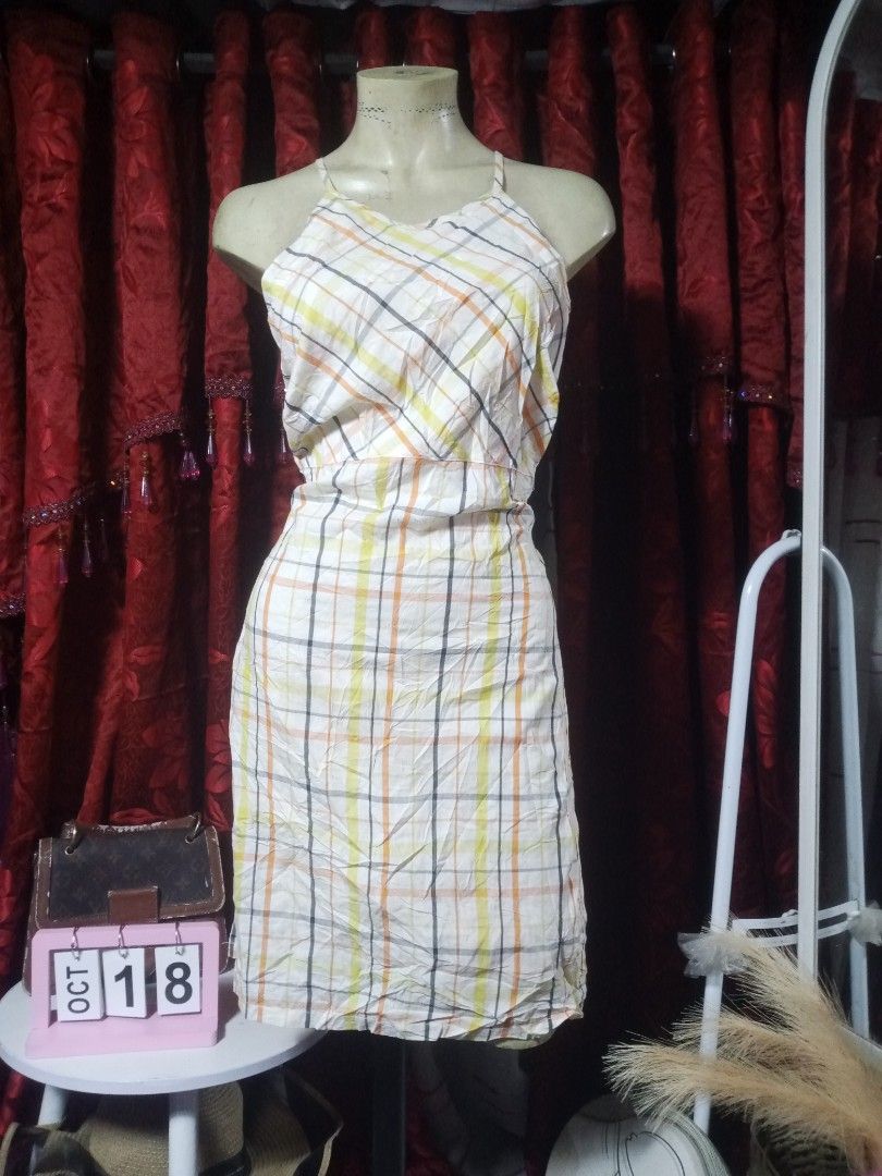 Halter midi dress (Category: Dresses) located in Manila. Submitted by wheneity67thifted (Listing ID 1469268373, Image 1). Description: This is a sleeveless, halter-neck midi dress featuring a cream-colored fabric with a yellow, orange, and black plaid check pattern..