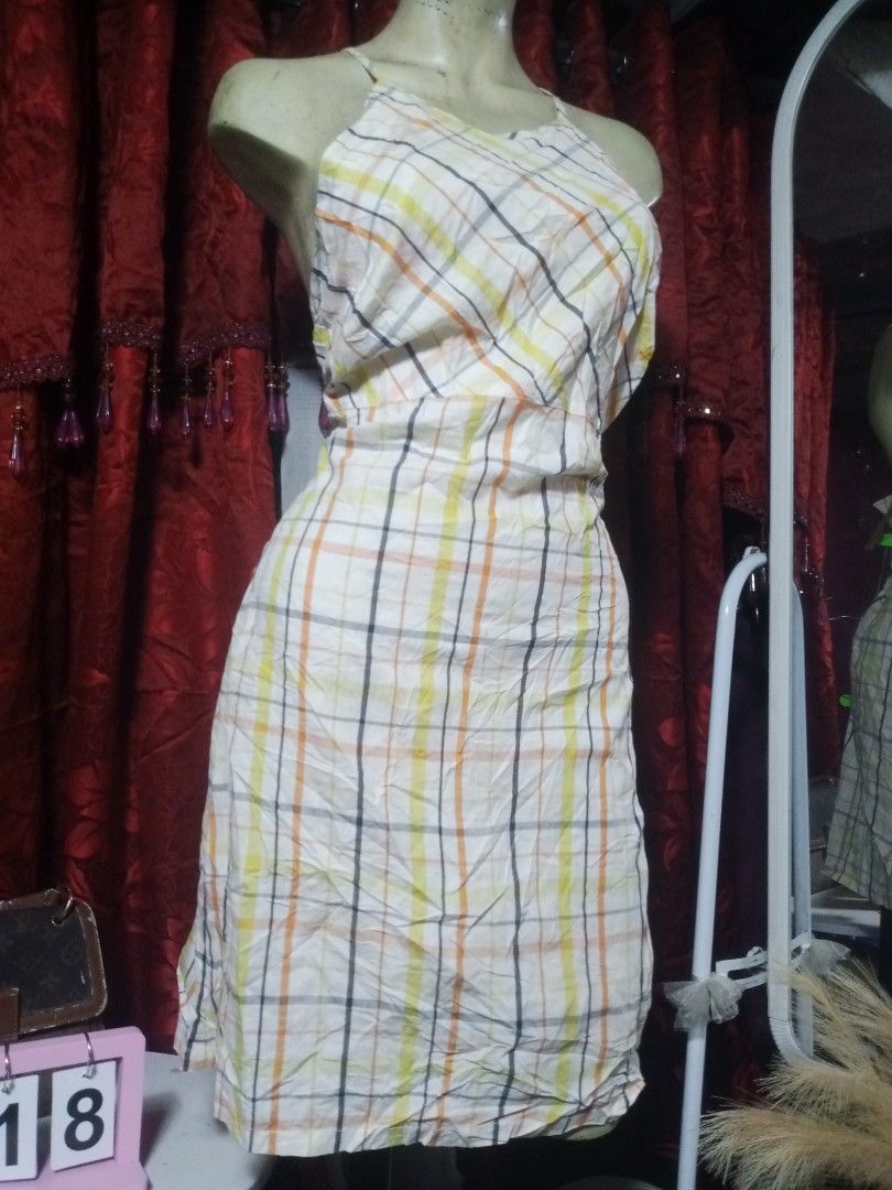 Halter midi dress (Category: Dresses) located in Manila. Submitted by wheneity67thifted (Listing ID 1469268373, Image 2). Description: This is a sleeveless, halter-neck midi dress featuring a cream-colored fabric with a yellow, orange, and black plaid check pattern..