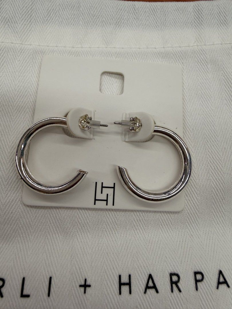 Harli + Harpa Silver Hoop Earrings (Category: Earrings) located in Quezon City. Submitted by ellamenopi (Listing ID 1469182279, Image 2). Description: - Brand: Harli + Harpa - Style: Silver hoop earrings (medium thickness, classic everyday design) - Condition: Brand new, never worn, still attached to original display card with secure backings - Inclusions: Original branded white dust bag and store card packaging - Perfect as a gift or a timeless 
