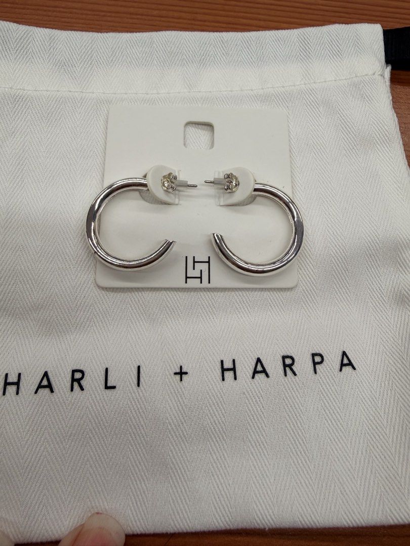 Harli + Harpa Silver Hoop Earrings (Category: Earrings) located in Quezon City. Submitted by ellamenopi (Listing ID 1469182279, Image 1). Description: - Brand: Harli + Harpa - Style: Silver hoop earrings (medium thickness, classic everyday design) - Condition: Brand new, never worn, still attached to original display card with secure backings - Inclusions: Original branded white dust bag and store card packaging - Perfect as a gift or a timeless 