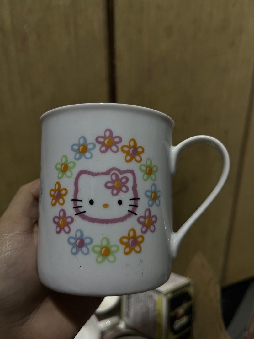 Hello Kitty ceramic mug with floral wreath pattern (Category: Coffee & Tea Tableware) located in Manila. Submitted by janetecson05 (Listing ID 1469251600, Image 1). Description: - Design: White ceramic mug featuring Kitty with a colorful floral wreath - Features: Classic right-side handle for a comfortable grip - Use: Ideal for daily coffee, tea, or your favorite hot beverages - Collection: A great addition to any Sanrio or Kitty collection - Con