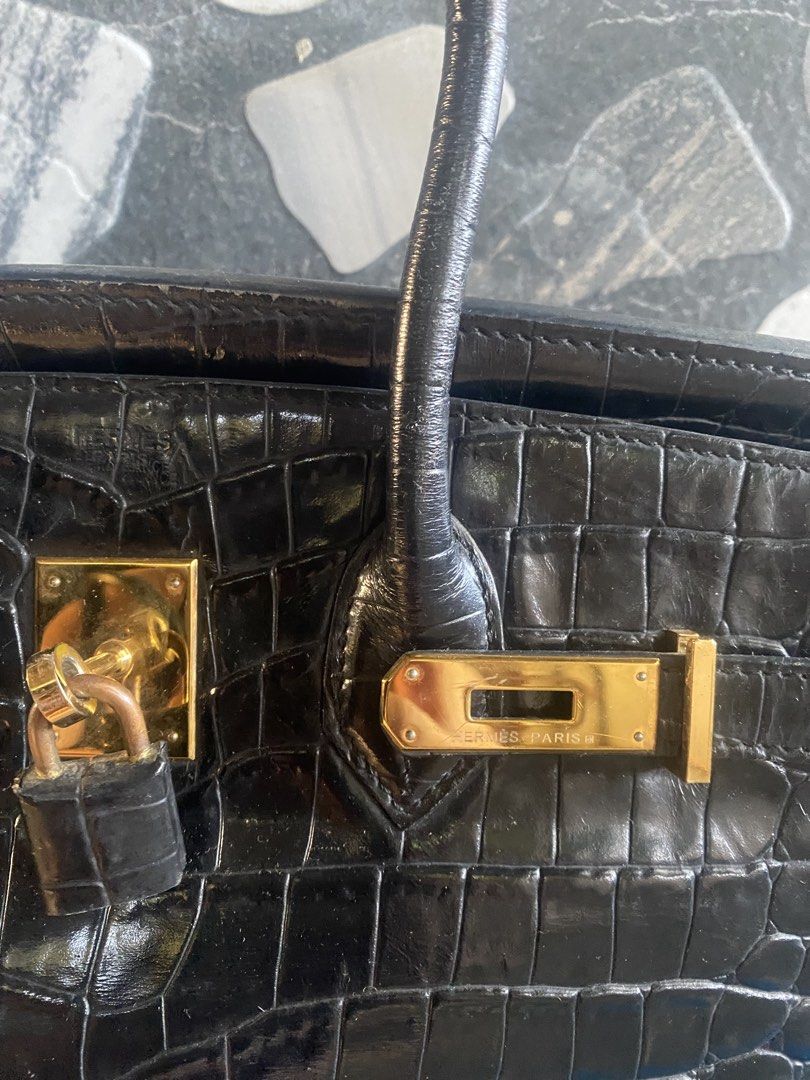 Hermès Birkin Crocodile Black Handbag (Category: Luxury Bags & Wallets) located in Bacolod City. Submitted by chuchaystuffs (Listing ID 1469165607, Image 2). Description: - Authentic Black Crocodile Hermès Birkin bag - Luxurious gold-toned hardware with included closure lock - Classic structured design featuring dual top handles - Stamped Hermès Paris signature on the front plate and hardware - Premium exotic skin body with substantial, rich text