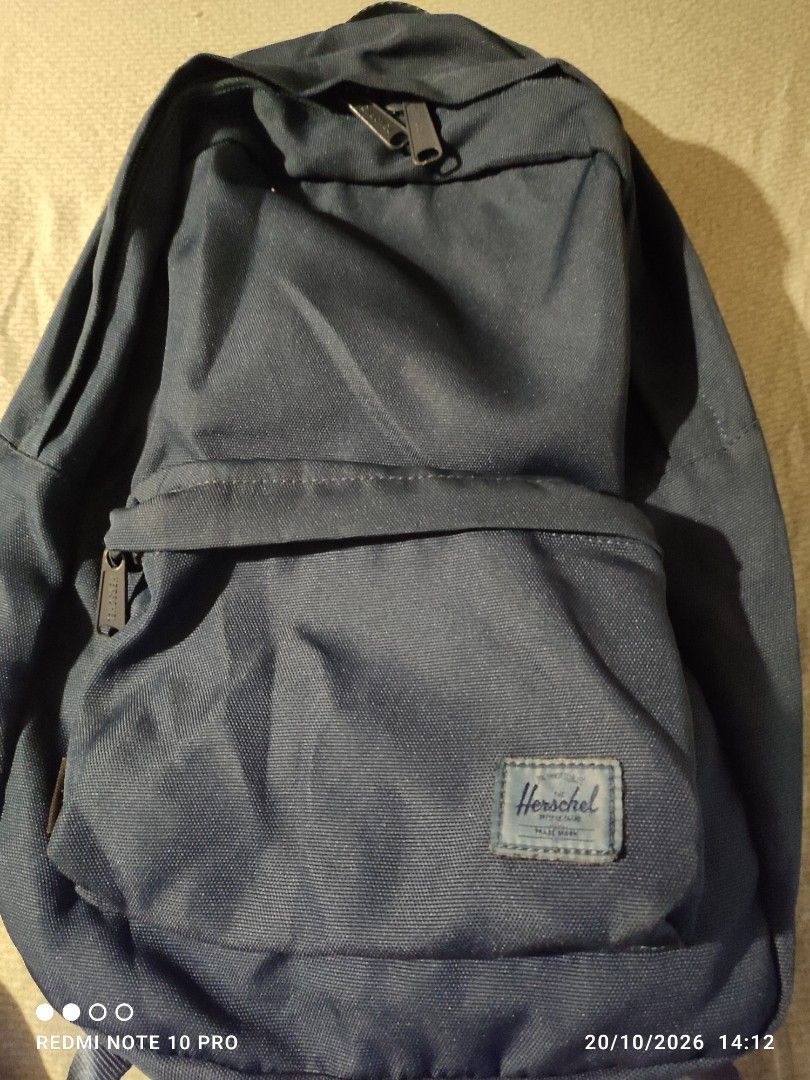Herschel Supply Co. Blue Backpack (Category: Backpacks) located in Manila. Submitted by laxer11 (Listing ID 1469218157, Image 1). Description: - Brand: Herschel Supply Co. - Color: Classic Navy Blue - Material: Durable canvas fabric - Interior: Signature striped inner lining with brand label - Exterior: Front pocket with classic woven brand label - Hardware: Sturdy zippers with branded pulls and adjustable straps with plastic hardware - Condition