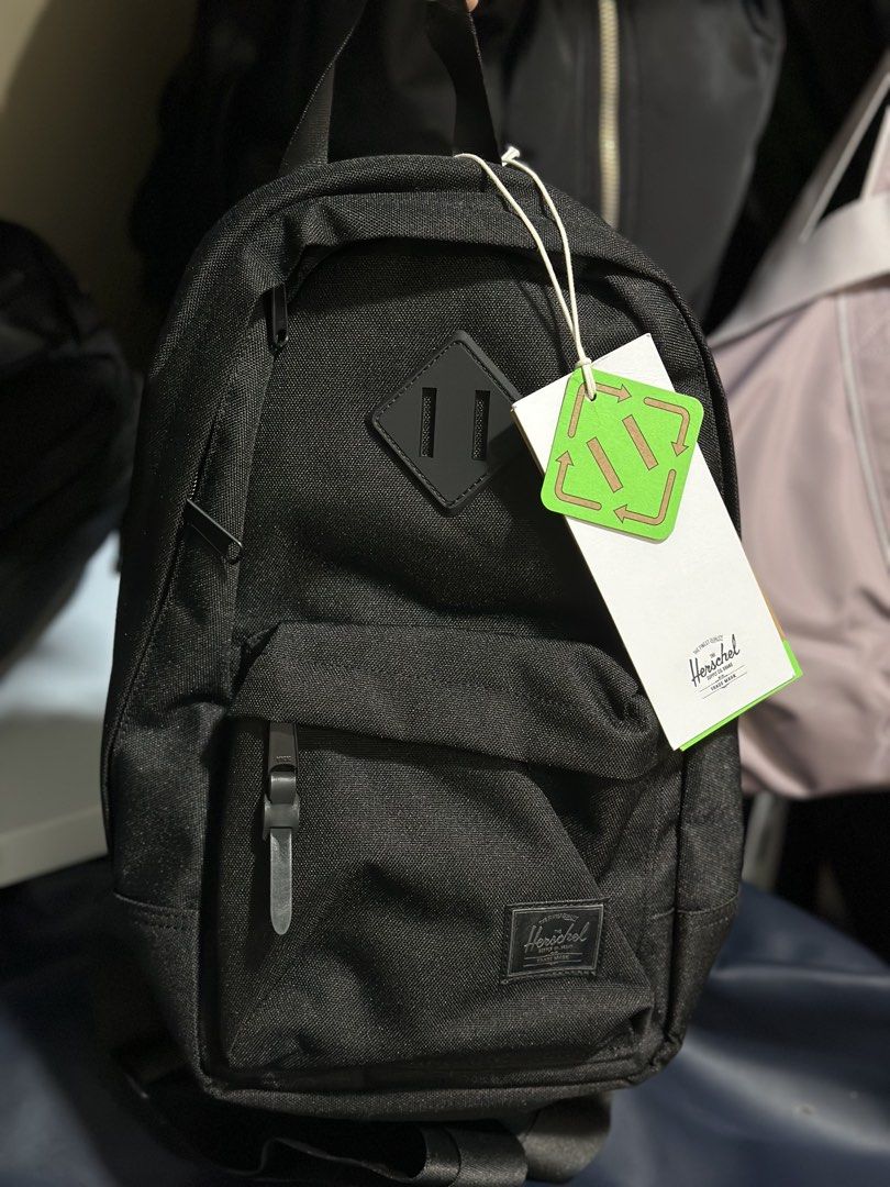 Herschel Supply Co. EcoSystem Recycled Fabric Black Backpack (Category: Luxury Bags & Wallets) located in Baguio. Submitted by annecicat (Listing ID 1469222552, Image 1). Description: - Brand: Herschel Supply Co. - Condition: Brand new with tags attached - Color: Classic black with signature front patch and diamond detail - Material: EcoSystem recycled fabric - Storage: Wide-opening main compartment, front zippered pocket, and inner pocket compar