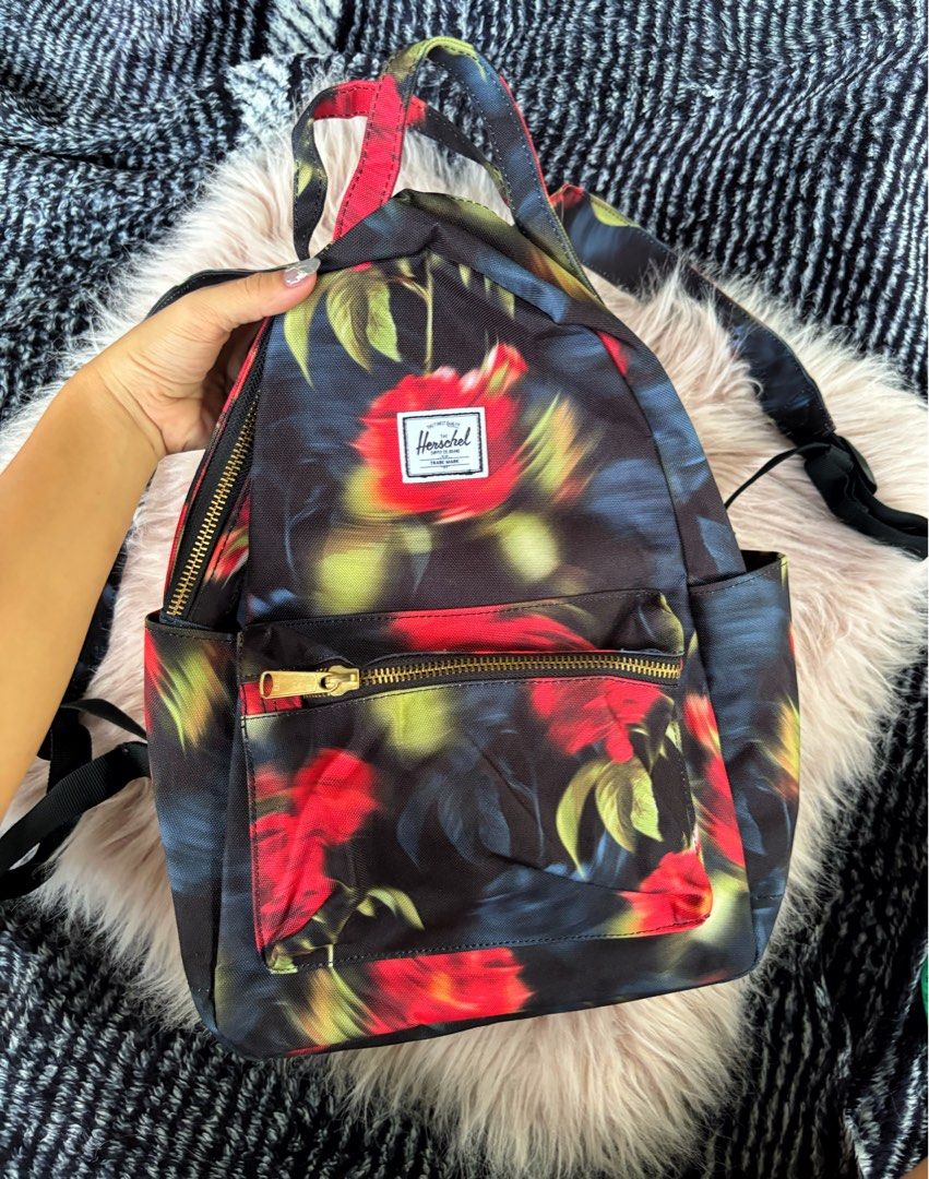 Herschel Supply Co. Floral Mini Backpack (Category: Backpacks) located in Digos. Submitted by kathydiane76376 (Listing ID 1469318952, Image 1). Description: - Brand: Herschel - Design: Moody red and black floral print with chic gold hardware - Storage: Main double-zipper closure and convenient front zip pocket - Comfort: Adjustable shoulder straps and sturdy top grab handle - Condition: Clean canvas fabric inside and out - Usage: Great everyday s