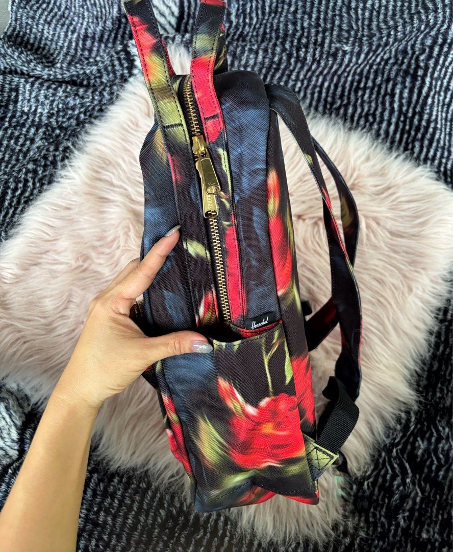 Herschel Supply Co. Floral Mini Backpack (Category: Backpacks) located in Digos. Submitted by kathydiane76376 (Listing ID 1469318952, Image 3). Description: - Brand: Herschel - Design: Moody red and black floral print with chic gold hardware - Storage: Main double-zipper closure and convenient front zip pocket - Comfort: Adjustable shoulder straps and sturdy top grab handle - Condition: Clean canvas fabric inside and out - Usage: Great everyday s