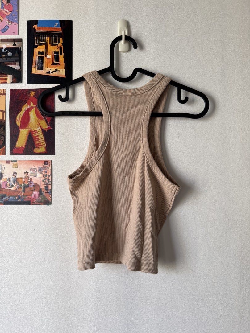 H&M Beige Racerback Tank Top (Category: Sleeveless) located in Makati City. Submitted by smolpapi (Listing ID 1469173592, Image 2). Description: Material: Super stretchy cotton blend Style: Racerback, ribbed crop tank top, fitted cut Condition: Never worn, no issues Can give discount for sure buyers or if getting 2 or more items!.