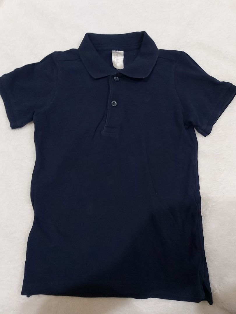 H&M Dark Blue Polo Shirt (Category: Babies & Kids Fashion) located in Manila. Submitted by sharmaine.24 (Listing ID 1469216793, Image 1). Description: - Brand: H&M - Color: Dark blue (solid) - Material: Soft cotton - Features: Short sleeves, classic collar, two-button placket - Condition: Clean and well-maintained.