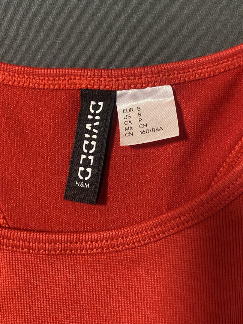 H&M Divided Red Racerback Tank Top Size S (Category: Sleeveless) located in Manila. Submitted by ms_spidey (Listing ID 1469181143, Image 2). Description: - Color: Bright red - Size: S (EUR/US S, CN 160/88A) - Style: Racerback with a high neckline - Material: Stretchy ribbed fabric - Condition: Brand new with hanger loops intact.
