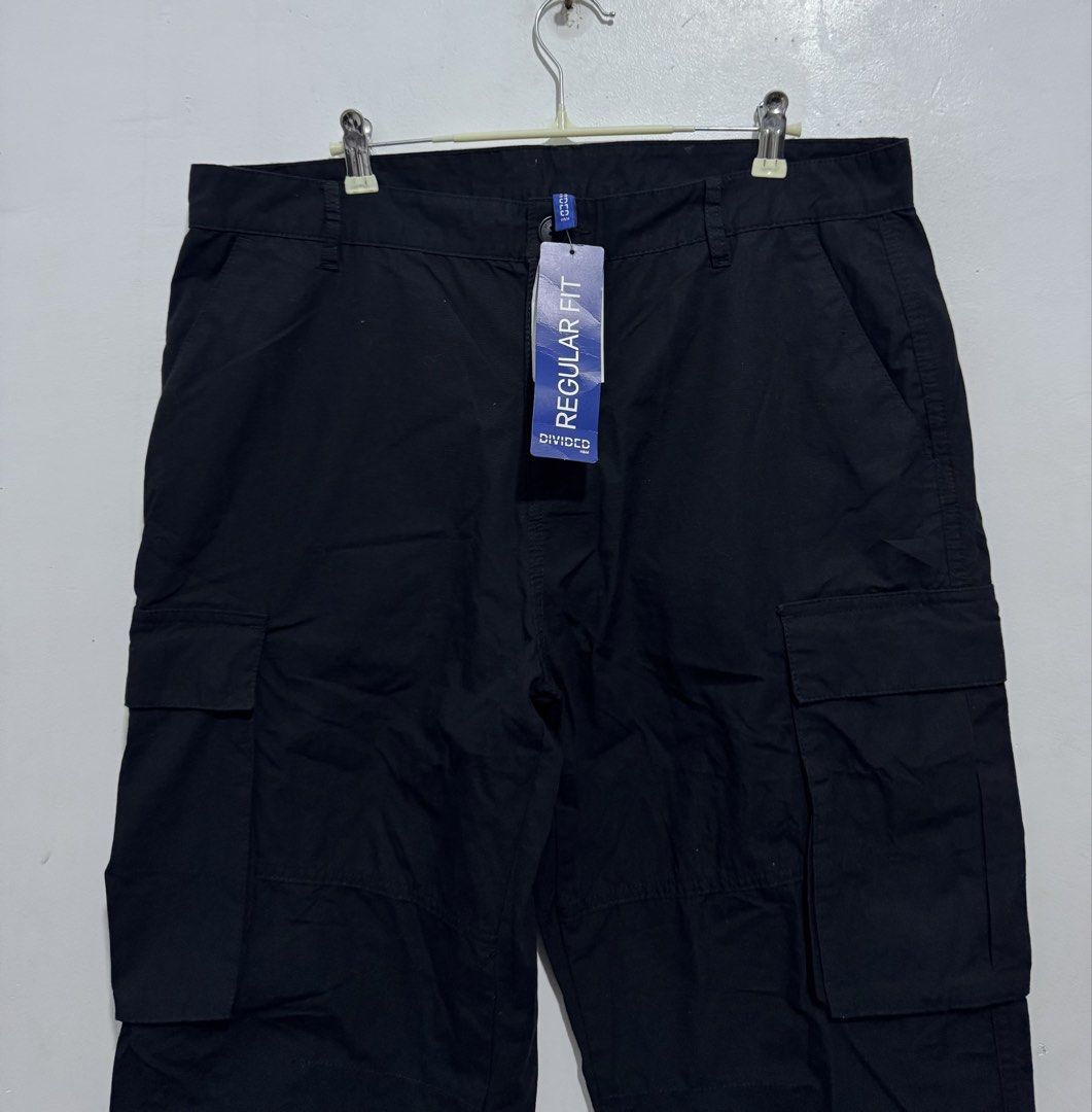 H&M Divided Regular Fit Cargo Pants Black Size 33/30 (Category: Jeans) located in Manila. Submitted by esparciake75752 (Listing ID 1469196550, Image 2). Description: - Brand: H&M Divided - Style: Cargo pants with multiple utility pockets - Color: Black - Fit: Regular fit with button closure and belt loops - Size: EUR 33/30, UK 33/30, CN 175/84A - Details: Adjustable drawstring cuffs at the bottom ankles - Condition: Brand new with original tags a