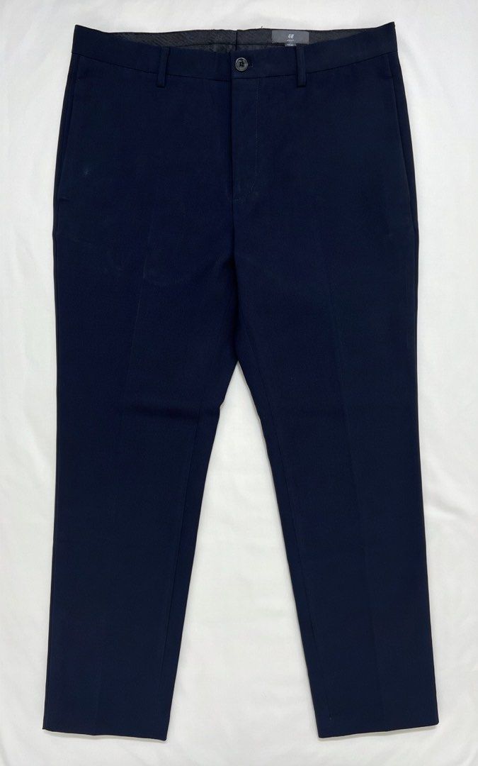 H&M Slim Fit Navy Trousers Size 34 (Category: Trousers) located in Quezon City. Submitted by aussomefinds (Listing ID 1467201815, Image 1). Description: - Brand: H&M - Item: Slim Fit Trousers - Color: Dark Navy - Size: 34 (EU/US/CA/MX) - Details: Rolled cuffs at the hem, single front button closure - Style: Clean tailoring, ideal for formal or smart-casual wear - Condition: Great for work or weekend outings.