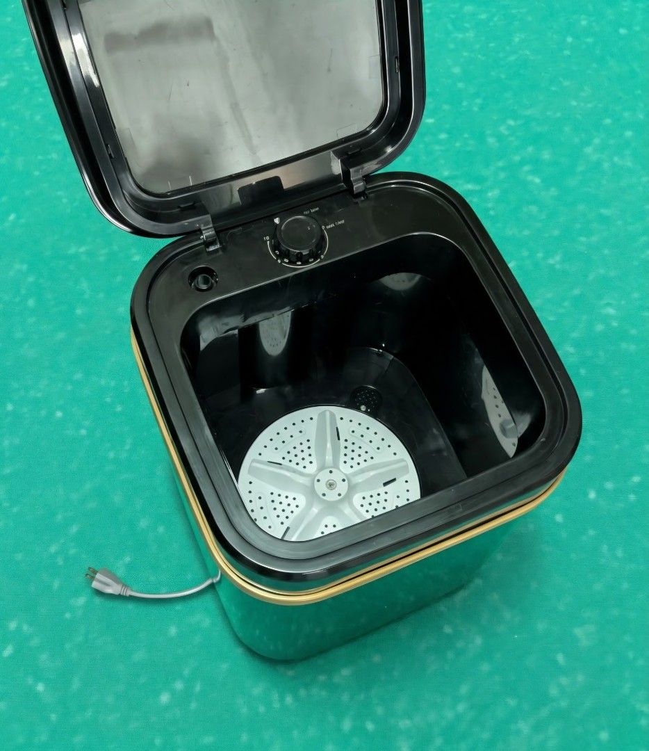 Hodekt Portable Mini Washing Machine (Category: Washing Machines and Dryers) located in Manila. Submitted by decluterring.co (Listing ID 1469254279, Image 2). Description: Issue: Capacitor, mahina ikot. Pwede bumili sa orange app around 100+ or Pagawa niyo nalang. - Brand: Hodekt - Color: Sleek black and grey design - Type: Top-loading with interior pulsator plate and top timer knob - Power: Standard plug-in with attached grey power cord - Ideal 