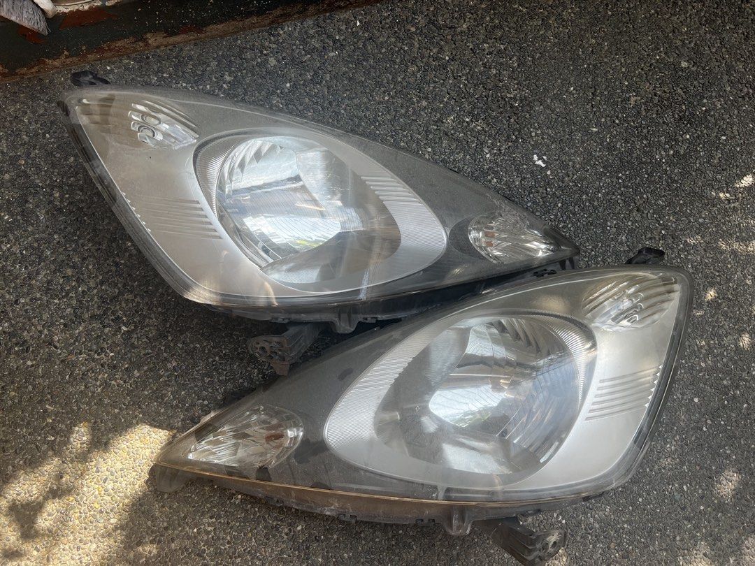 Honda Jazz GE Pre - MMC Headlight Assembly (Category: Lightings, Horns, and other Electrical Parts and Accessories) located in Quezon City. Submitted by digital_ryan (Listing ID 1469283738, Image 1). Description: For Sale: Used Honda Jazz GE Pre- MMC Headlight Assembly With FREE Novsight LED Bulb Complete Brackets issue: Sun Peeling but does not affect light .